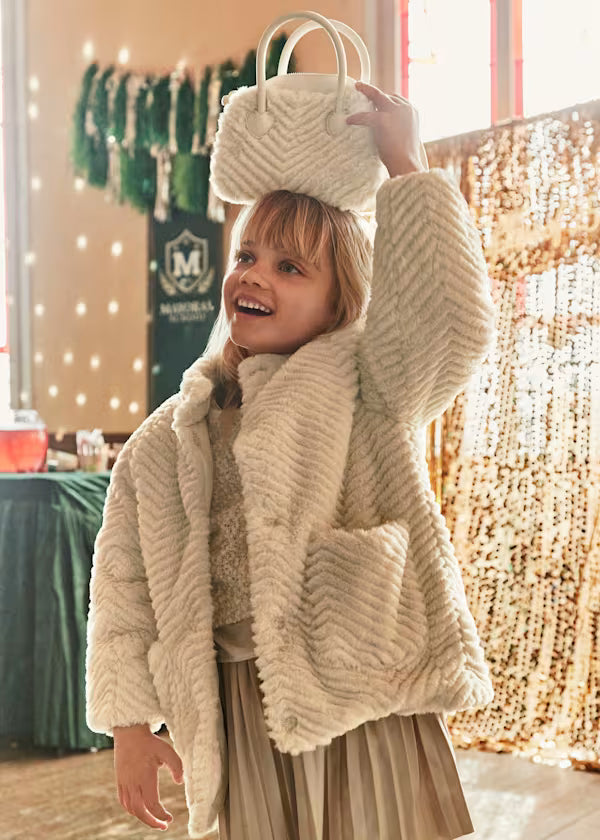 Girl wearing warm CAPPOTTO PELLICCIA Mayoral coat with matching bag in cozy cream polyester fleece