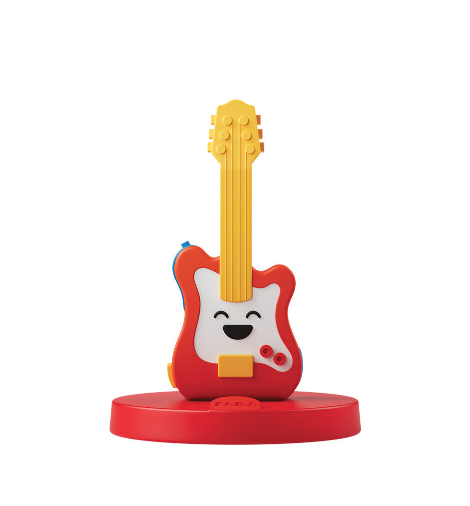 Colorful toy electric guitar with happy face on red base representing rock’n’roll music for kids and families