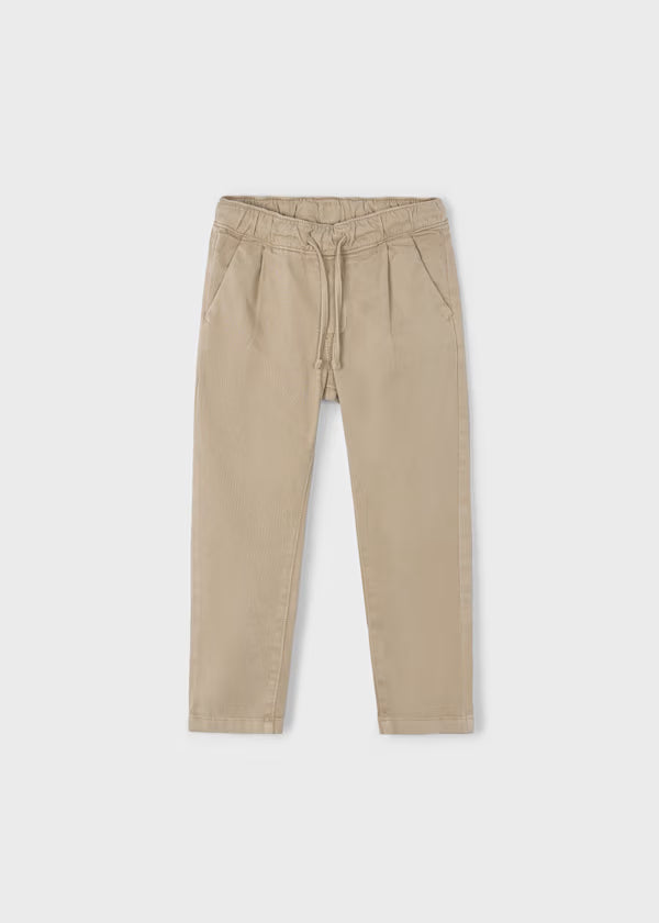 Beige boy's jogger pants with adjustable elastic waist and drawstring, tapered ankles, made from Better Cotton.